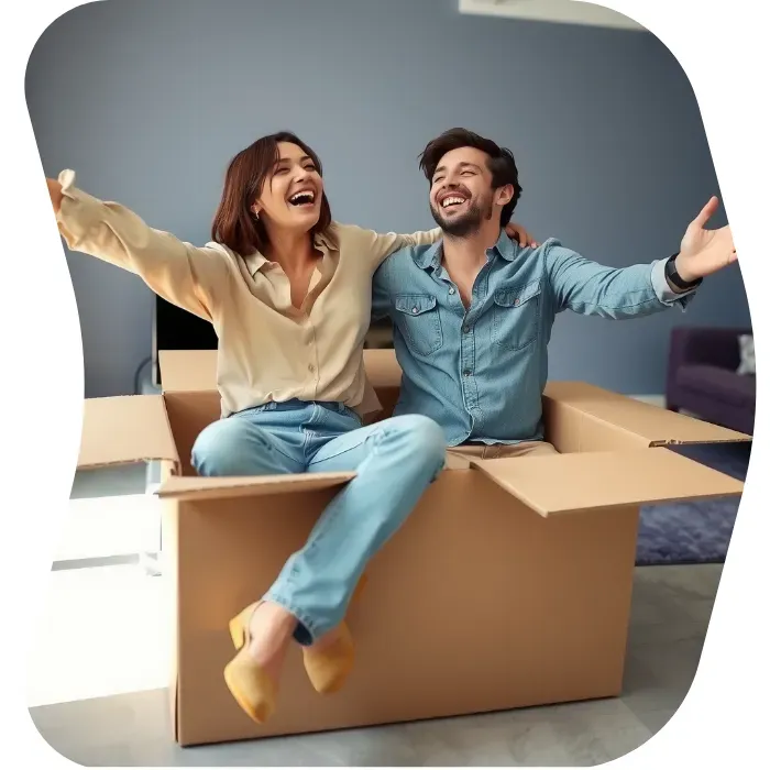 Two guys sitting on the floor of their apartment with Muval moving boxes
